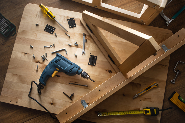 Top view of drill tool and another equipment on wood table furniture