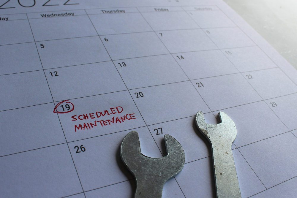 Scheduled maintenance concept. Spanner and calendar with text SCHEDULED MAINTENANCE