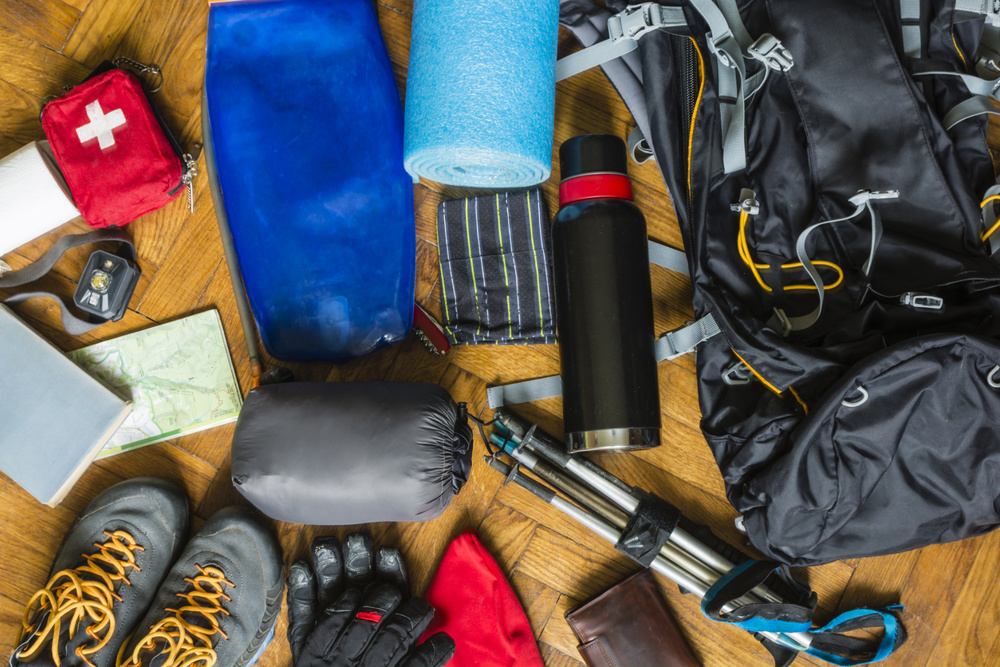 Equipment that would fit into a backpack to go out on a trail in the mountains
